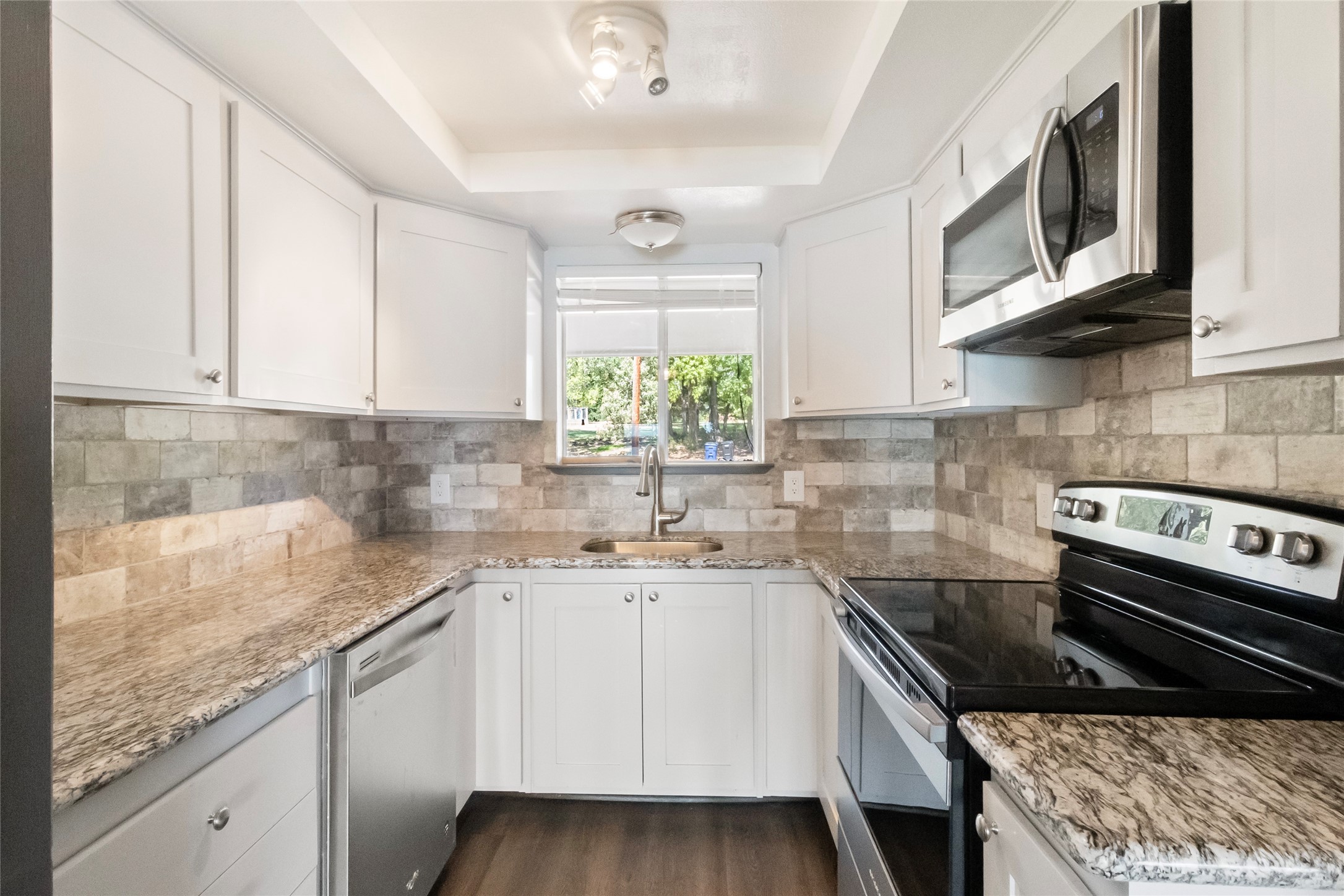 344 Peach Island Trinity, TX 75862 - Photo 6 of 15 a kitchen with a sink stove and microwave