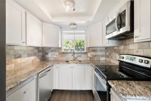 a kitchen with a sink stove and microwave