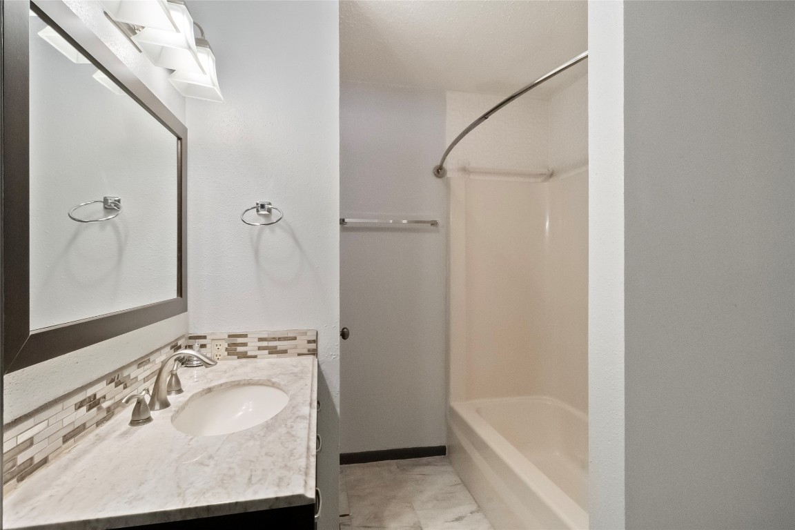 344 Peach Island Trinity, TX 75862 - Photo 10 of 15 a bathroom with a tub sink and mirror