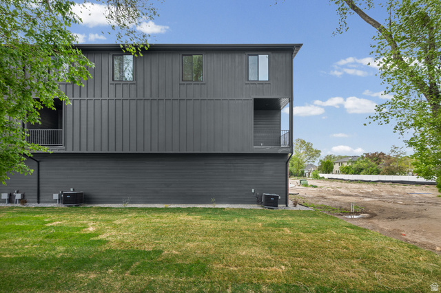 340 East 7635 S Street Sandy, UT 84047 - Photo 29 of 32 Rear view of house with a balcony and a lawn