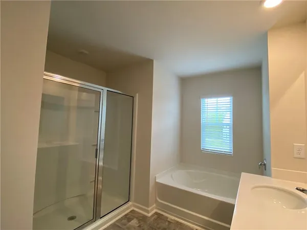 a bathroom with a bathtub and a shower