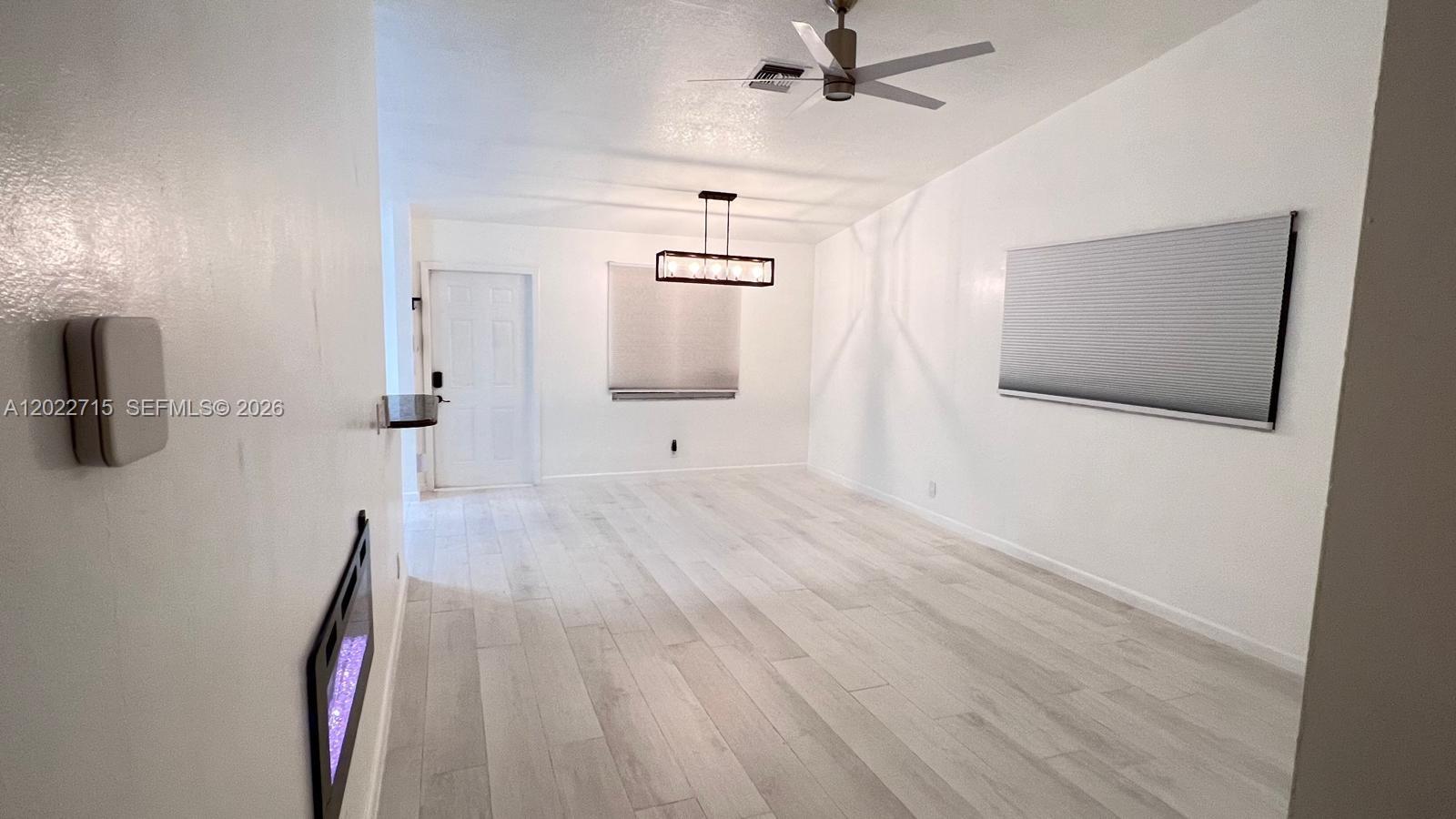 10669 Boca Entrada Boulevard Boca Raton, FL 33428 - Photo 6 of 19 a view of a livingroom with wooden floor and staircase
