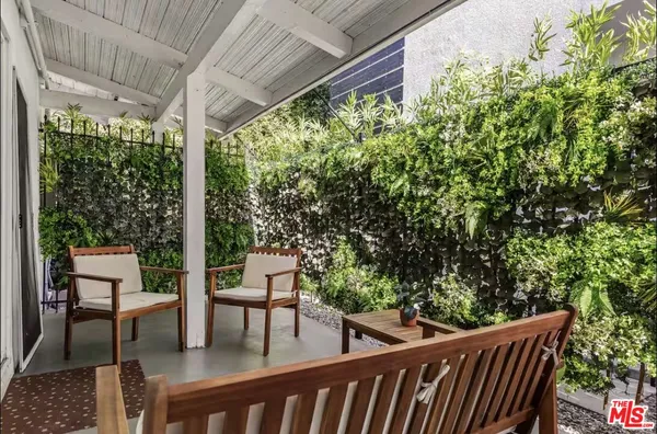 a view of a two chairs in the patio