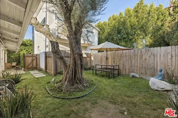 a backyard of a house with table and chairs