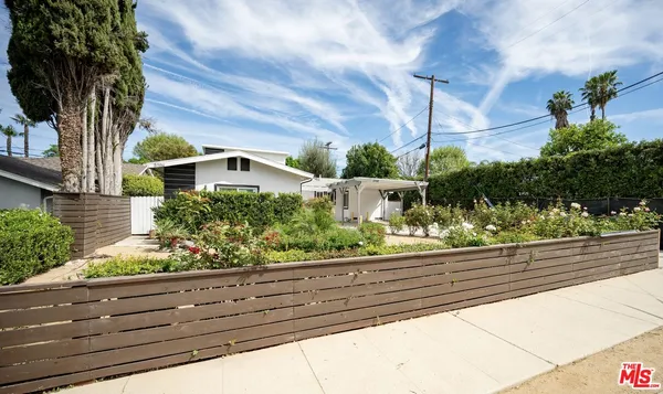 a view of a yard and front view of a house