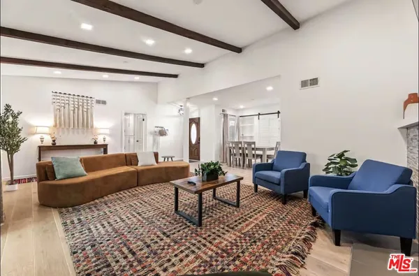 a living room with furniture and a rug
