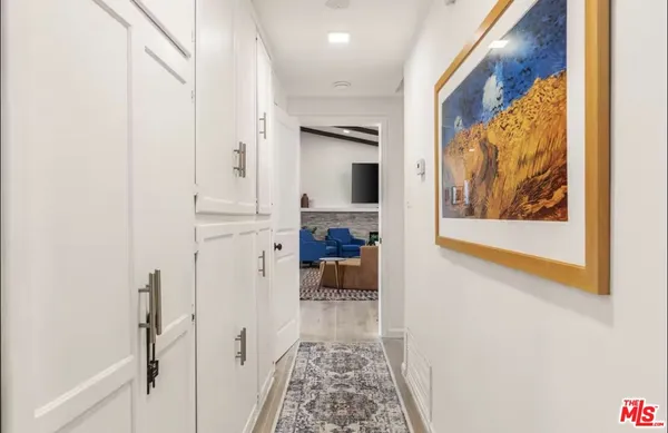 a view of a hallway view with furniture and a fireplace
