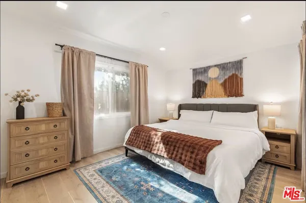 a bedroom with a bed and a dresser
