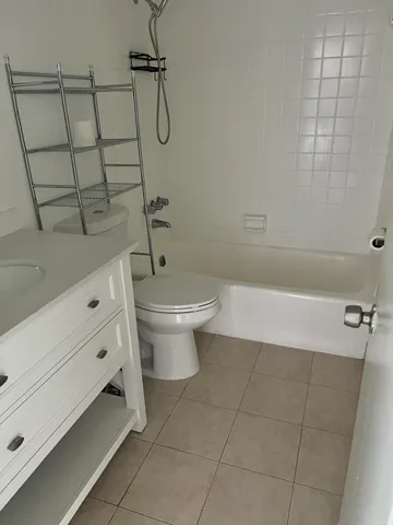 a bathroom with a shower a toilet and sink