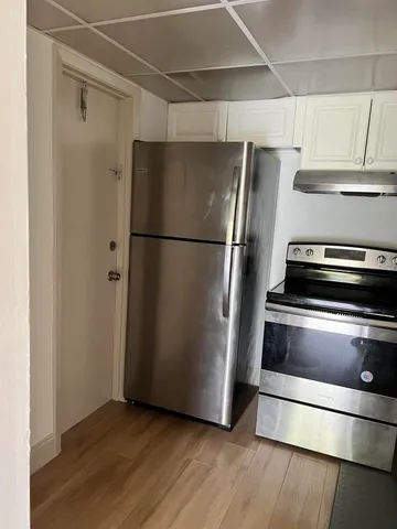 a metallic refrigerator freezer sitting in a kitchen