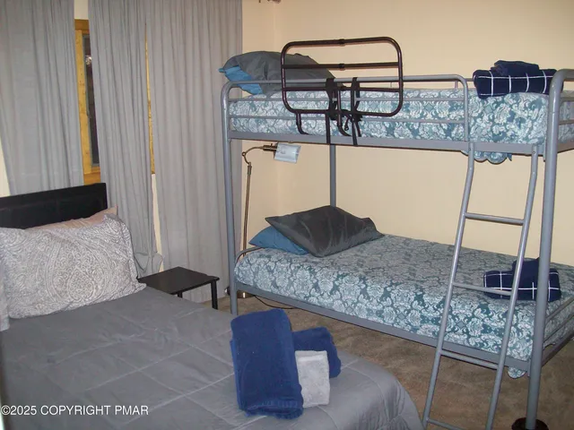 a bedroom with a bed and dresser