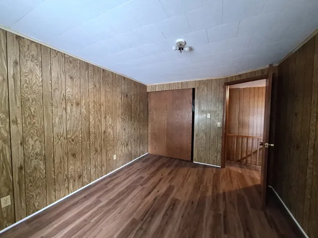 a view of hallway with wooden floor