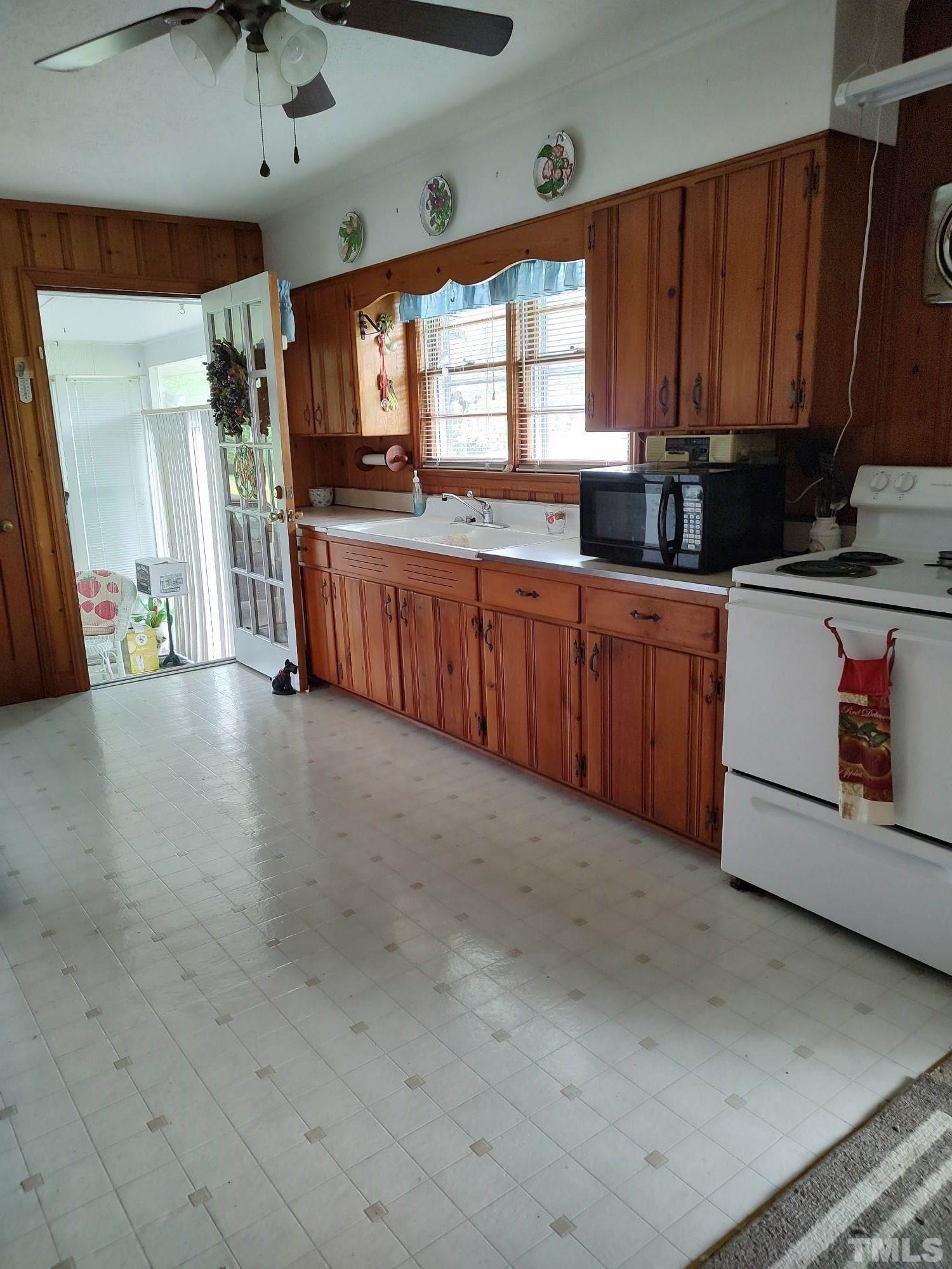8727 Peacock Road Whiteville, NC 28472 - Photo 11 of 25 a kitchen with stainless steel appliances granite countertop a stove a sink and a microwave