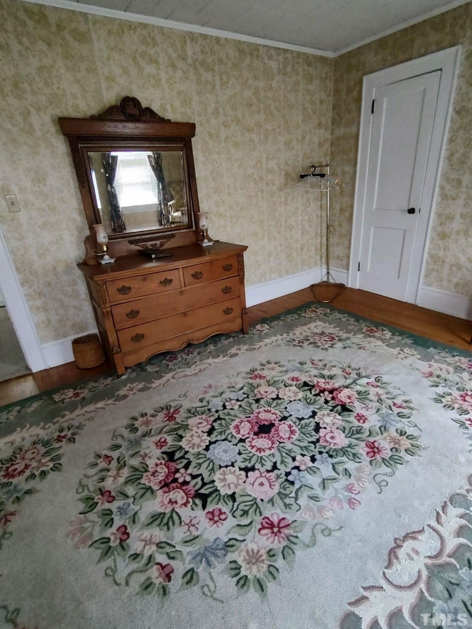 8727 Peacock Road Whiteville, NC 28472 - Photo 23 of 25 a living room with a bed and dresser