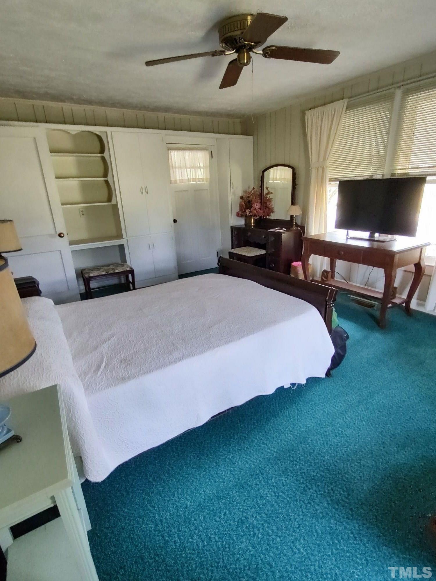 8727 Peacock Road Whiteville, NC 28472 - Photo 25 of 25 a spacious bedroom with a bed and a chandelier