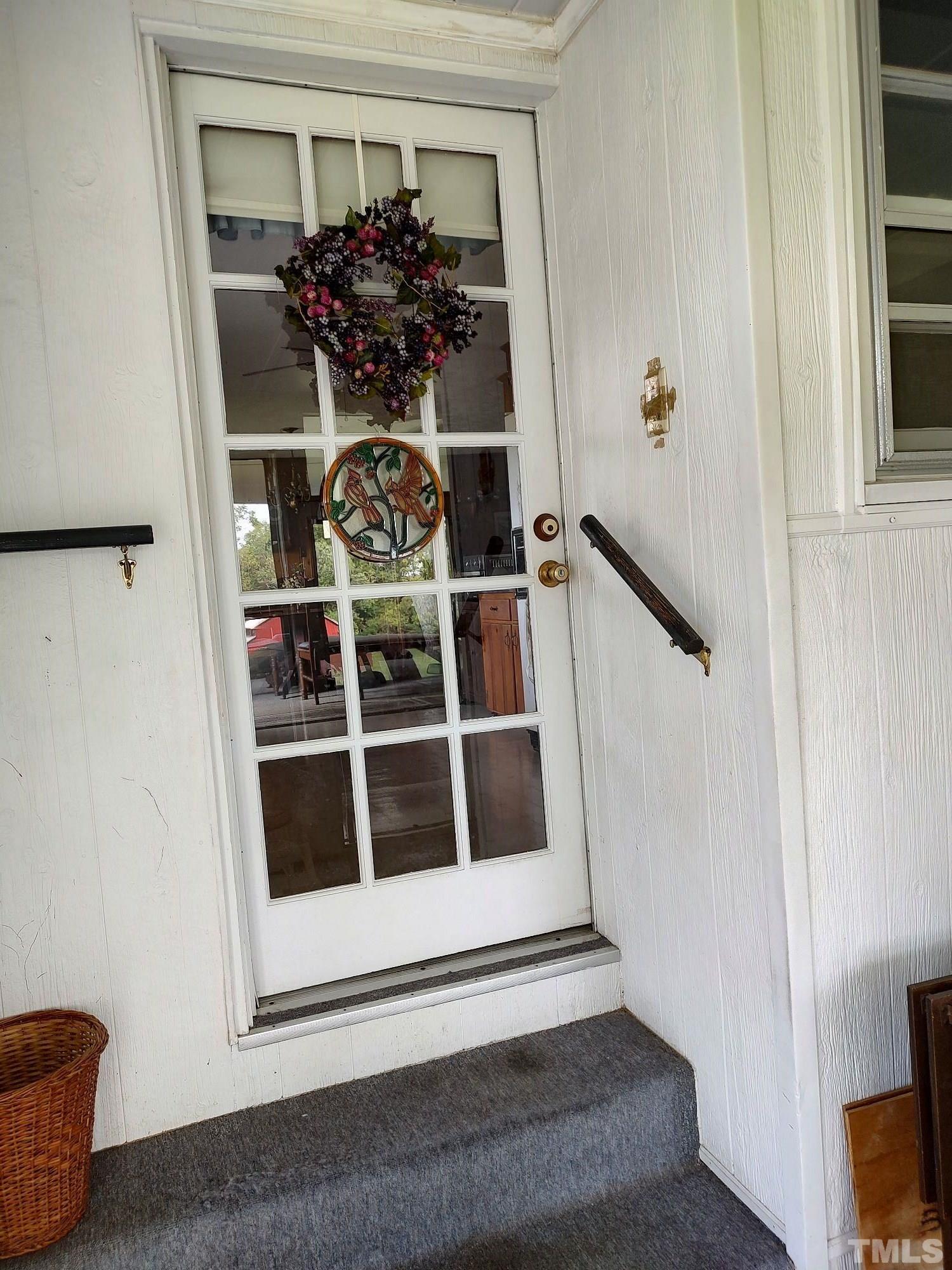 8727 Peacock Road Whiteville, NC 28472 - Photo 8 of 25 a view of a hallway with wooden cabinet and door