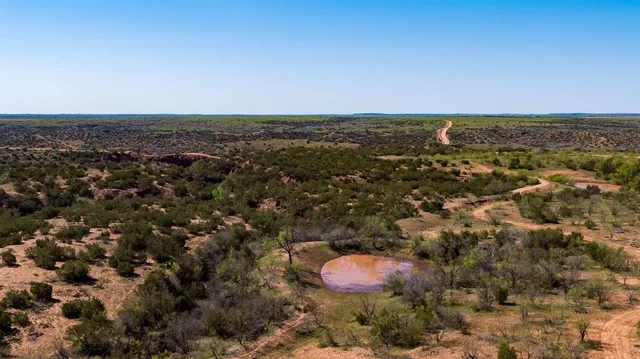 an aerial view of a houses with a yard