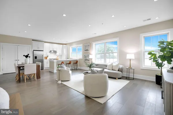 a living room with furniture dining table and a large window