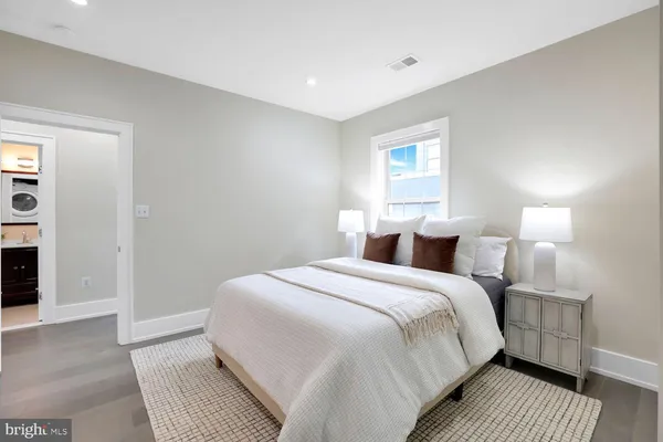 a bed room with a bed and a night stand