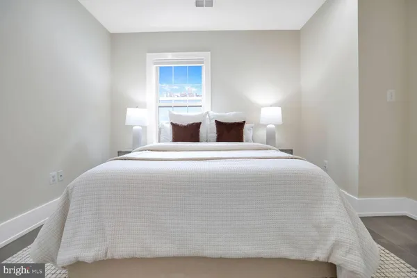 a bedroom with a bed and window