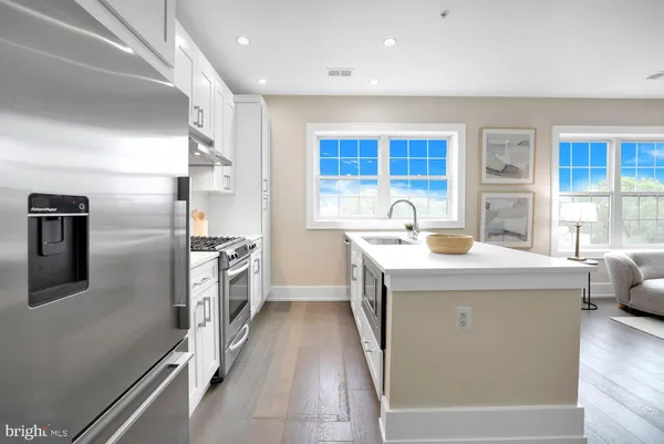 a kitchen with a sink appliances and cabinets
