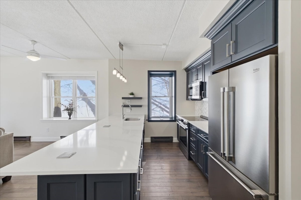 7A Eugene Circle, Unit B Boston, MA 02130 - Photo 11 of 42 a kitchen with stainless steel appliances a refrigerator and a stove