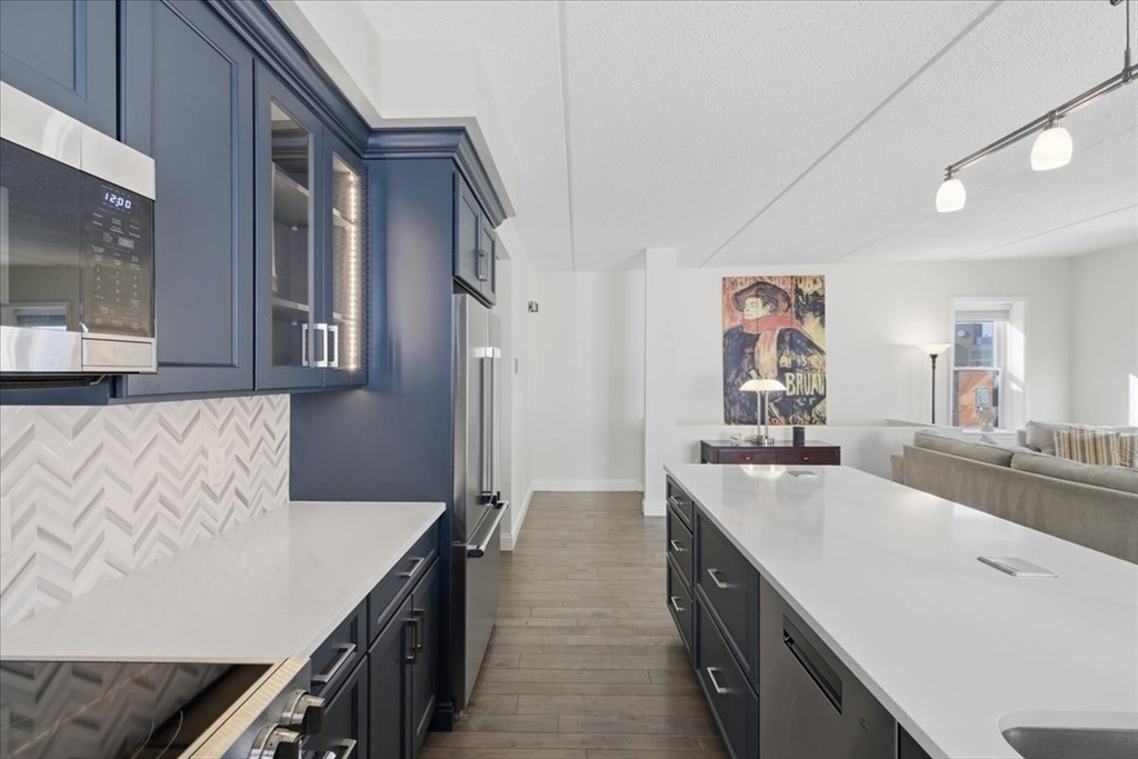 7A Eugene Circle, Unit B Boston, MA 02130 - Photo 12 of 42 a kitchen with stainless steel appliances a sink dishwasher stove and refrigerator
