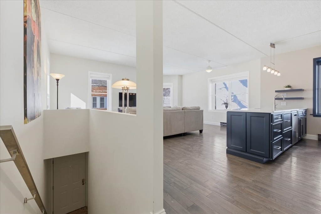 7A Eugene Circle, Unit B Boston, MA 02130 - Photo 13 of 42 a living room with furniture and a kitchen view