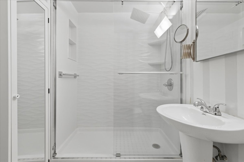 7A Eugene Circle, Unit B Boston, MA 02130 - Photo 15 of 42 a bathroom with a shower a sink and a mirror