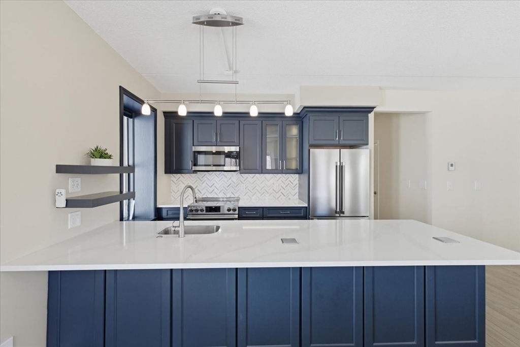 7A Eugene Circle, Unit B Boston, MA 02130 - Photo 6 of 42 a kitchen with stainless steel appliances a sink a counter space and cabinets