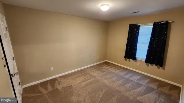 a view of walk in closet with clothes