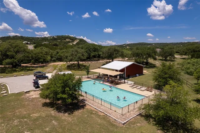 an aerial view of a house with a yard basket ball court and outdoor seating