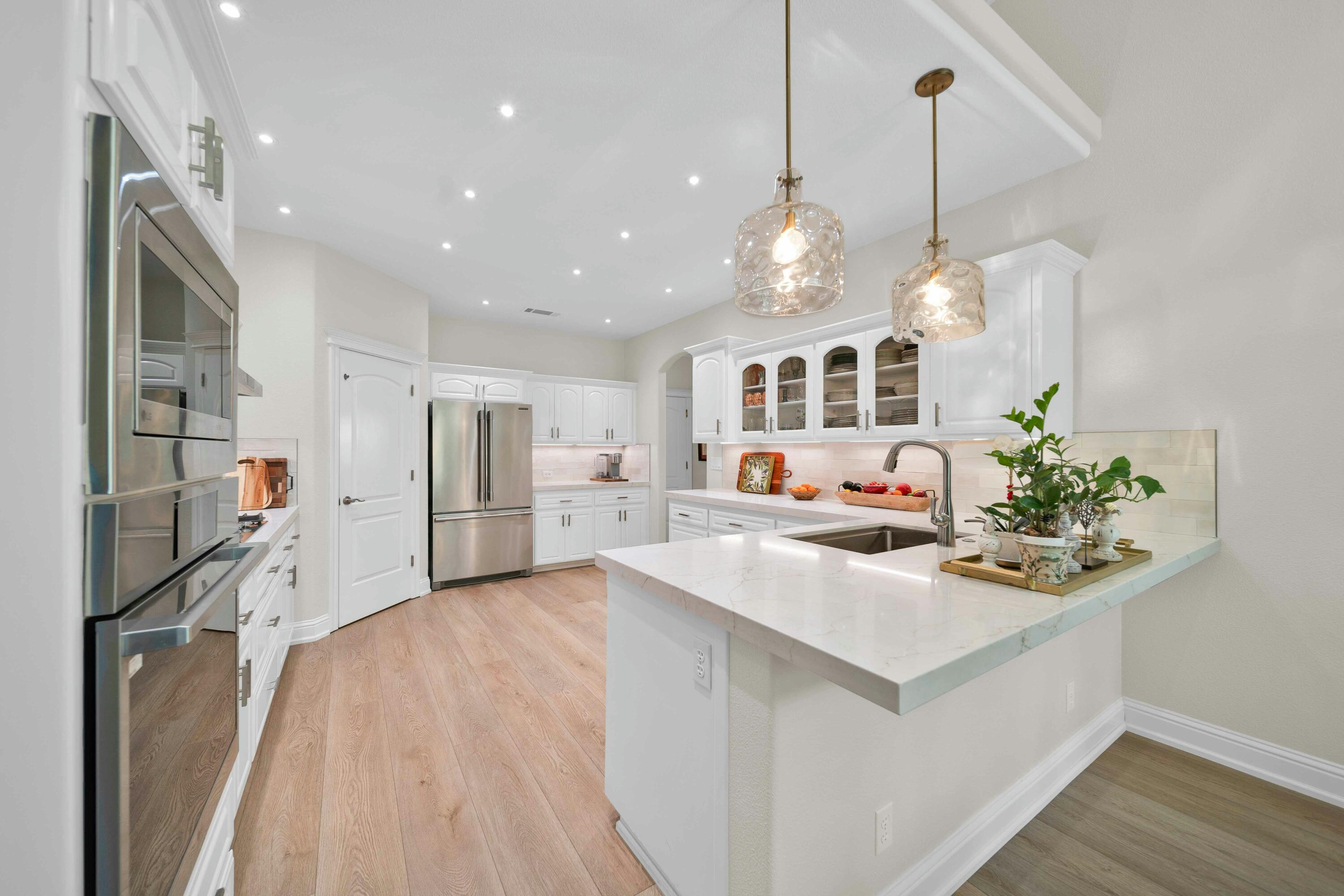 4045 Mt Whitney Way Redding, CA 96002 - Photo 29 of 78 a kitchen with stainless steel appliances kitchen island granite countertop a sink and a refrigerator