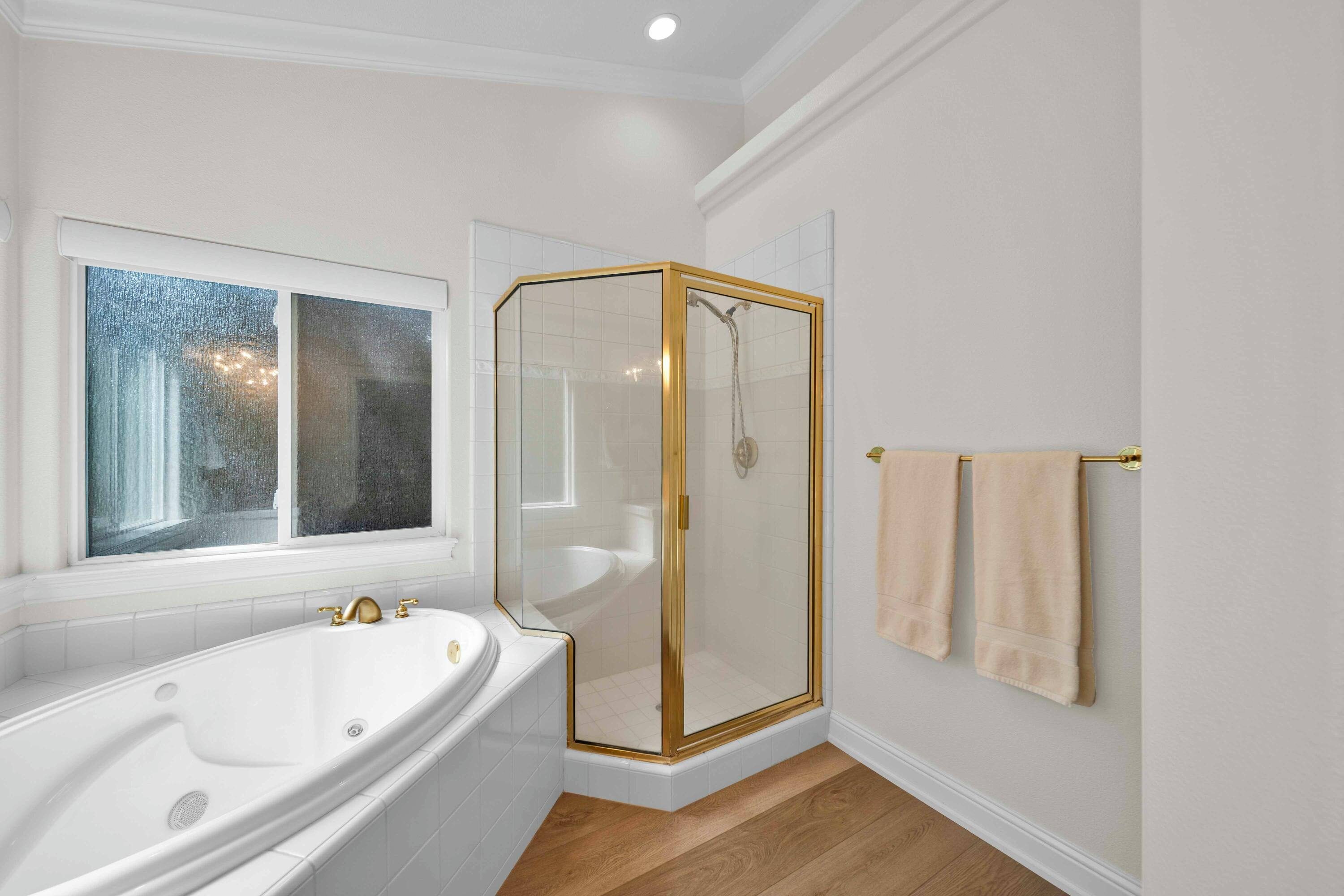 4045 Mt Whitney Way Redding, CA 96002 - Photo 53 of 78 a bathroom with a tub a mirror and a shower