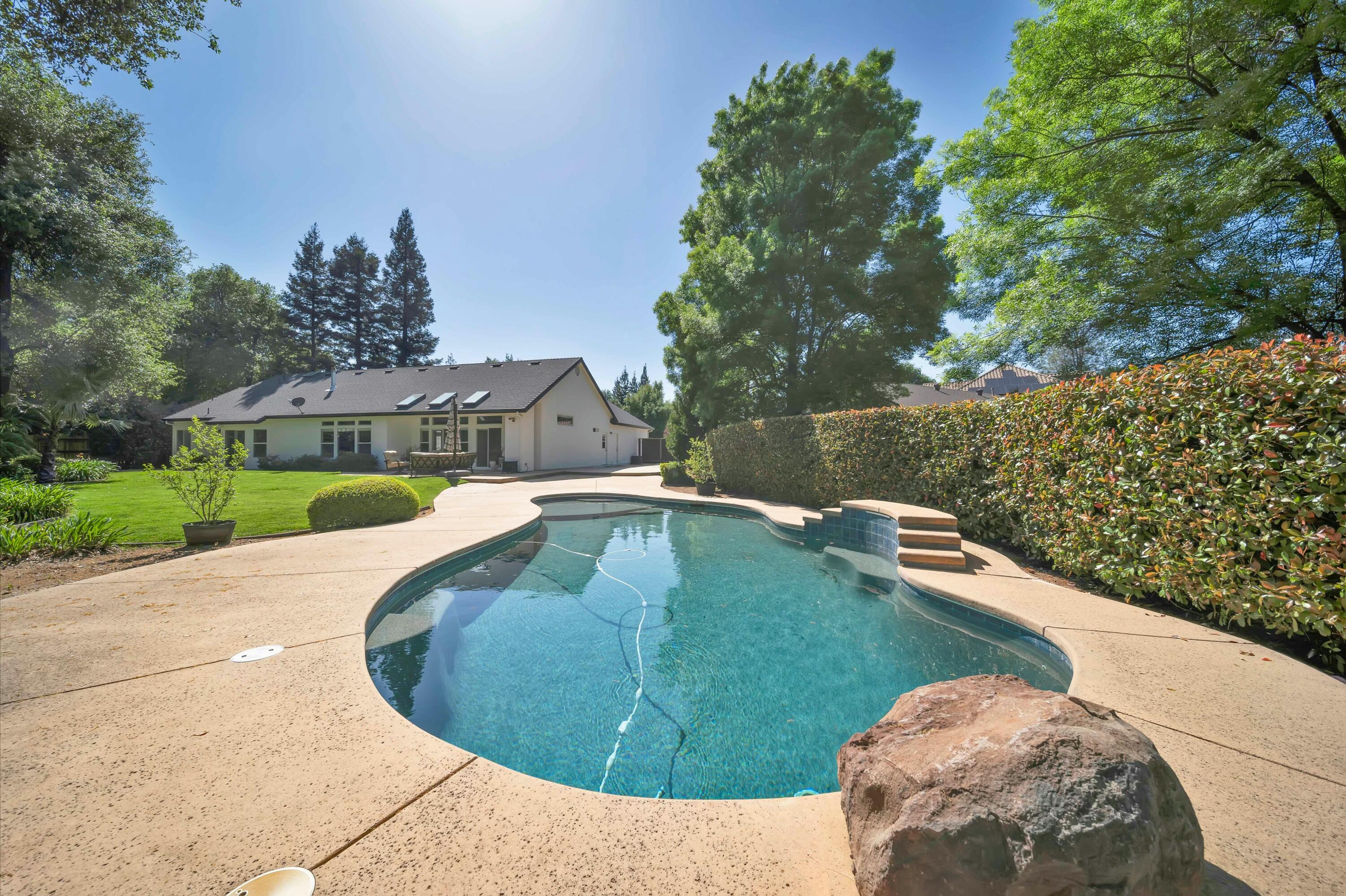 4045 Mt Whitney Way Redding, CA 96002 - Photo 58 of 78 a view of a swimming pool with a yard