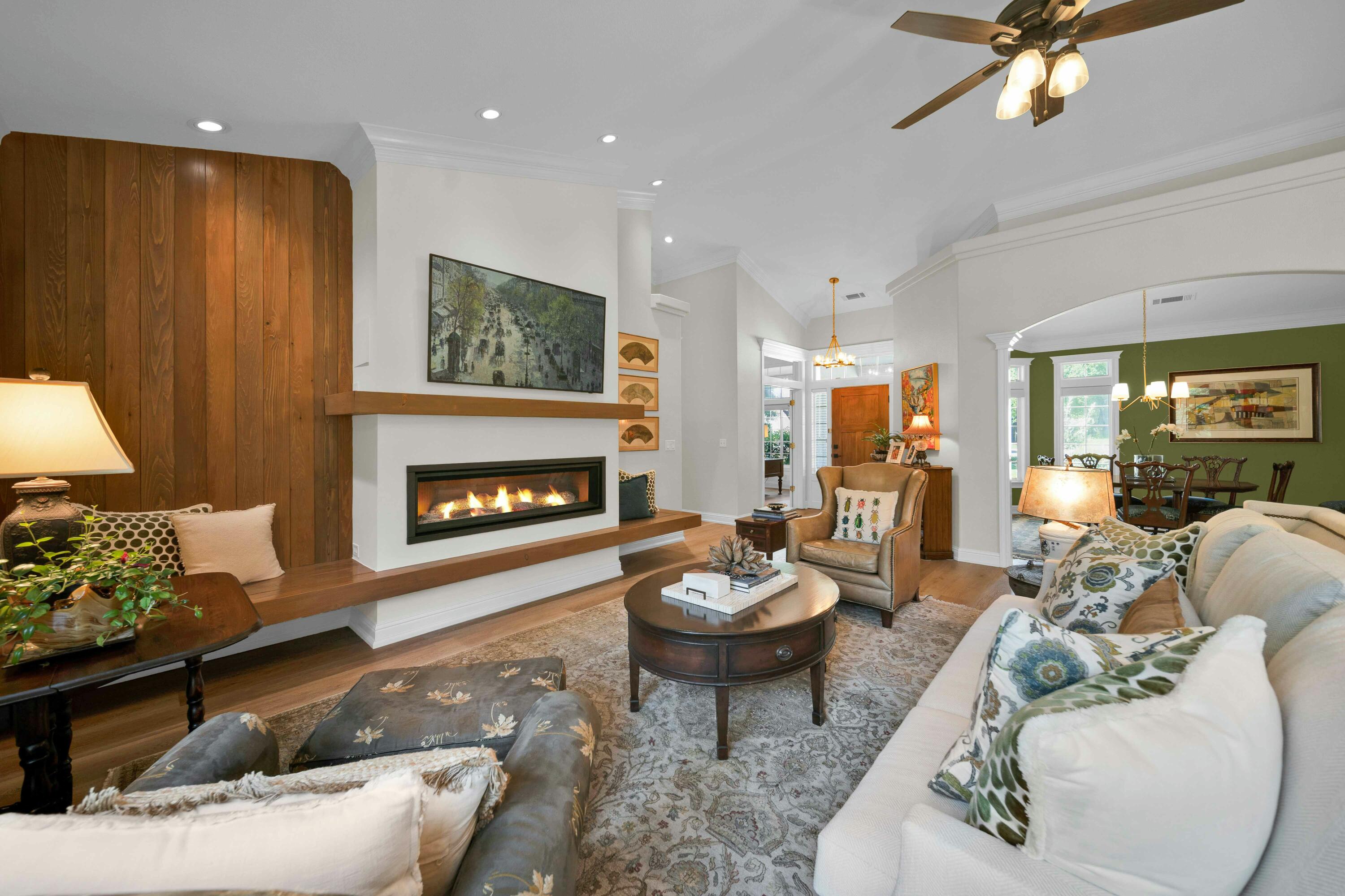 4045 Mt Whitney Way Redding, CA 96002 - Photo 10 of 78 a living room with furniture a fireplace and a chandelier