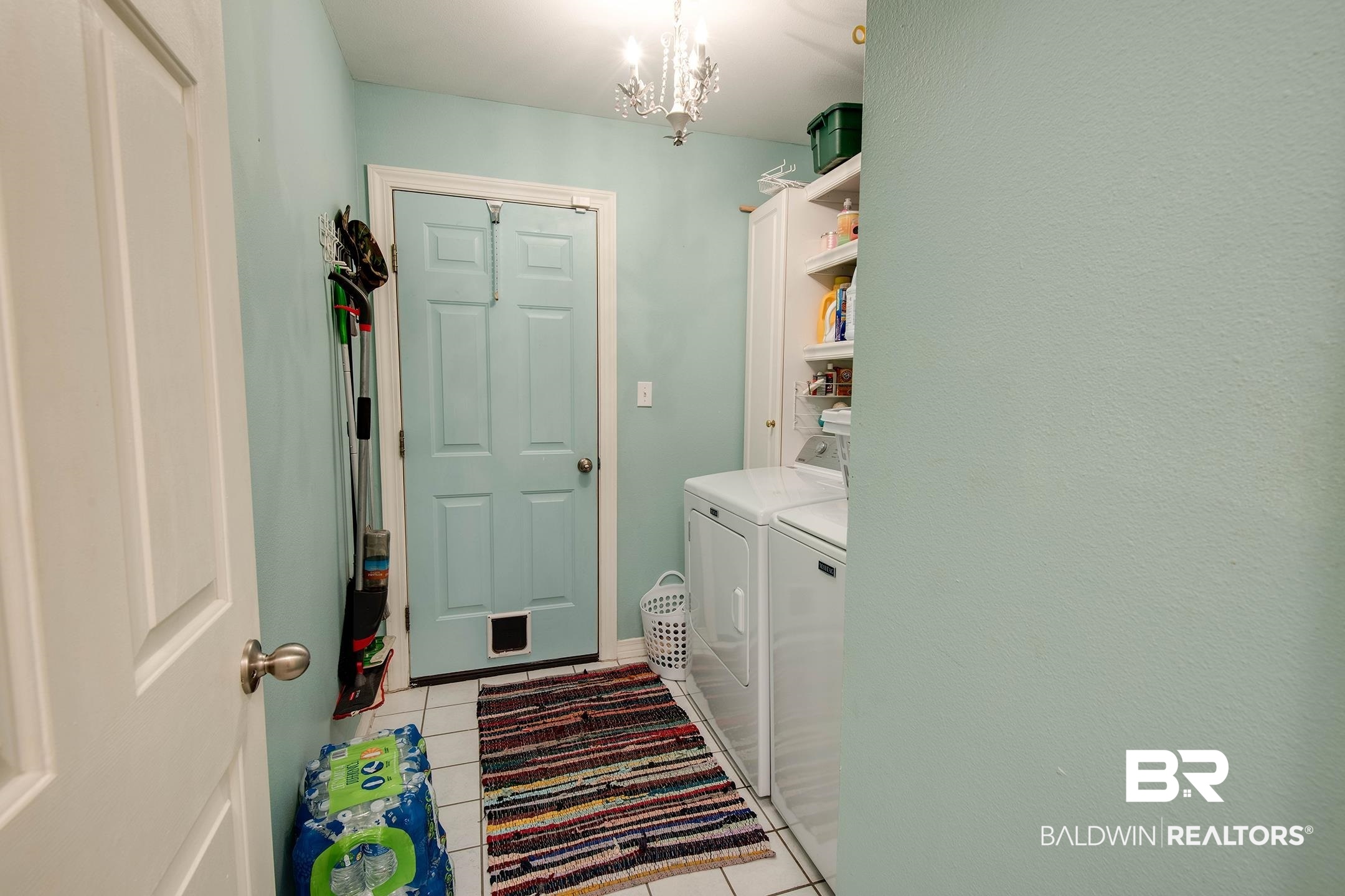 10093 Willis Road Foley, AL 36535 - Photo 14 of 33 Laundry area featuring washer and dryer, a chandelier, and light tile patterned floors
