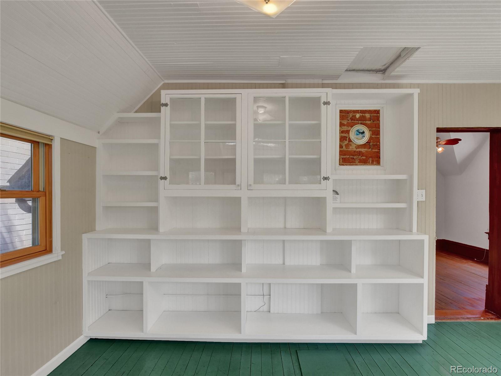 3349 Tejon Street Denver, CO 80211 - Photo 26 of 37 a view of an empty room with a window and wooden floor