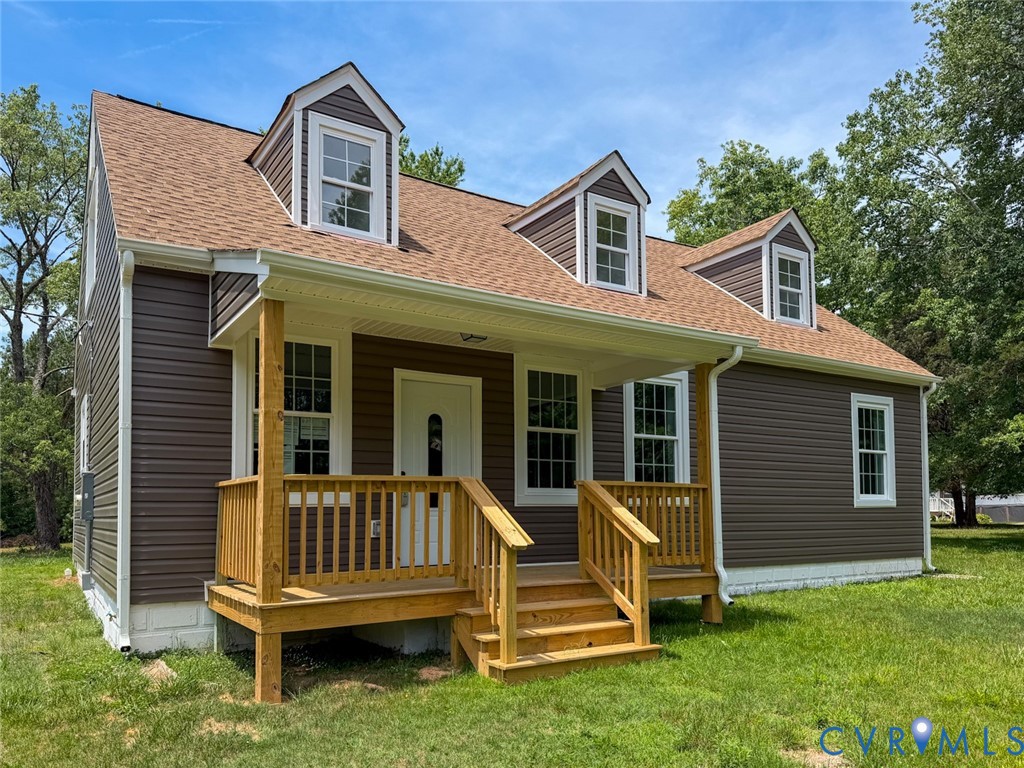 a view of a house with a yard and deck