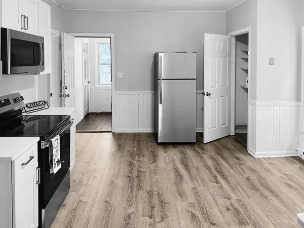 a kitchen with a refrigerator and a stove top oven
