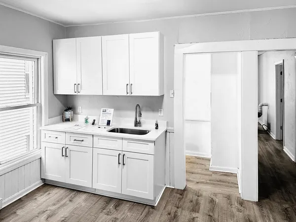 a kitchen with stainless steel appliances white cabinets and a sink