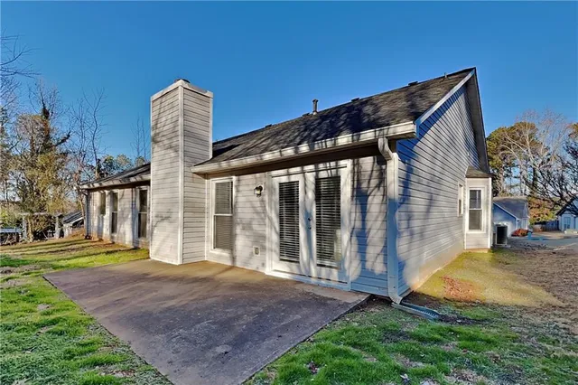 a front view of a house with a yard table and chairs