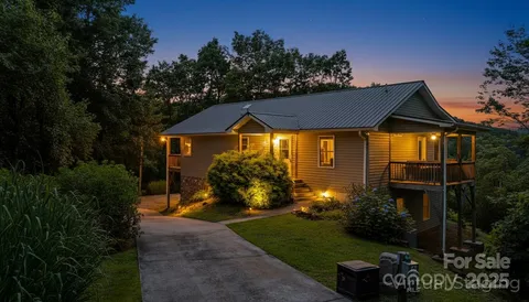 a front view of a house with a yard and outdoor seating