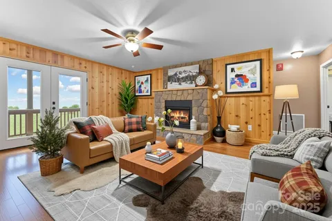 a living room with furniture a chandelier and a fireplace