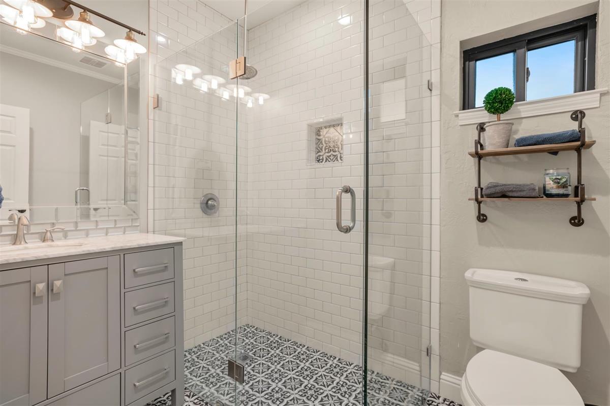 14355 Quito Road Saratoga, CA 95070 - Photo 44 of 50 a bathroom with a granite countertop sink toilet and shower