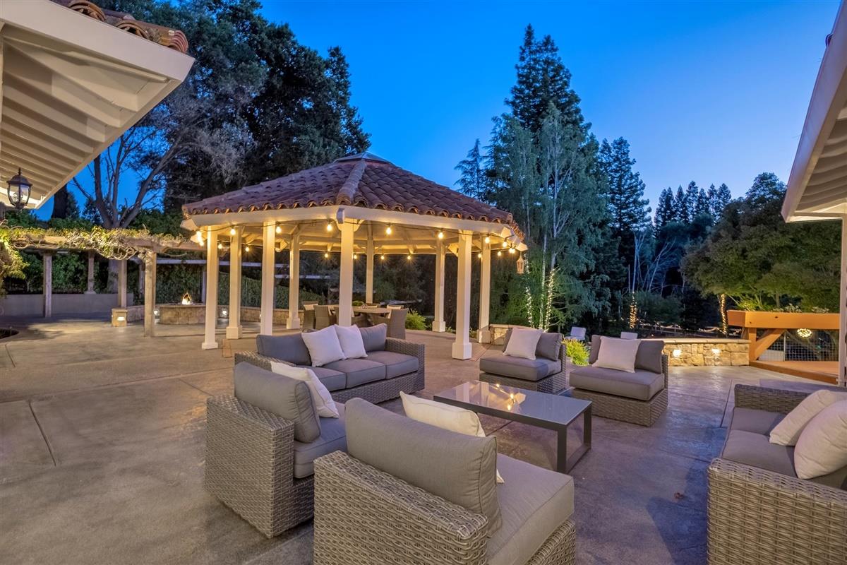 14355 Quito Road Saratoga, CA 95070 - Photo 47 of 50 a view of a patio with couches and table and chairs with floor to ceiling window and yard