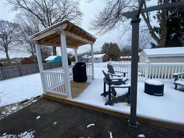a view of a roof deck with table and chairs and wooden floor