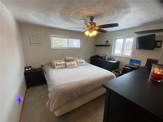 a bedroom with two beds and a flat screen tv