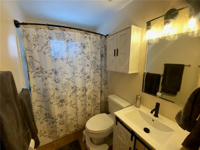 a bathroom with a sink toilet and mirror