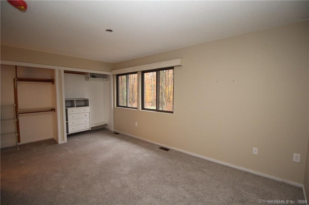 7 Woods Way, Unit 7 Woodbury, CT 06798 - Photo 11 of 19 a view of an empty room with a window